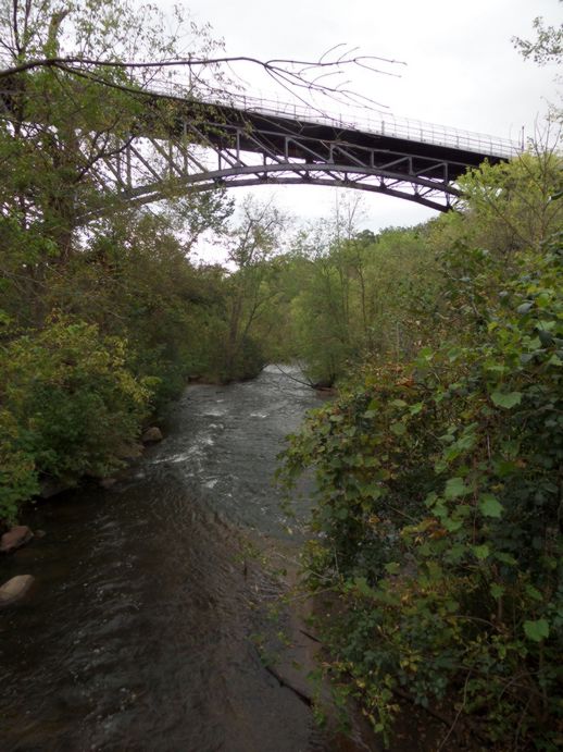 A bridge over a stream viewed from below.