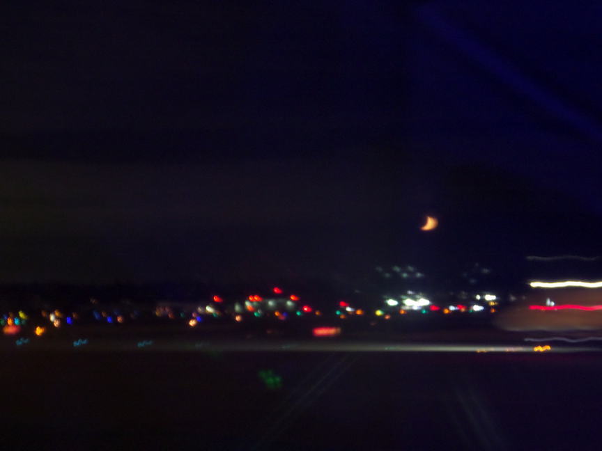 blurry yellow crescent moon in the dark.