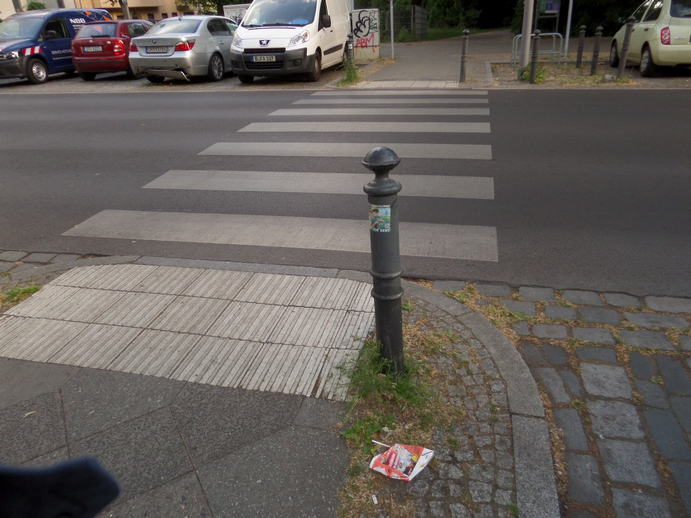 a flattened juicebox next to the street.