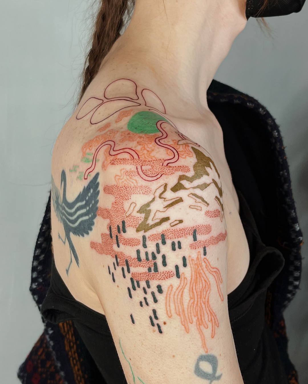 abstract and colorful shoulder tattoo.