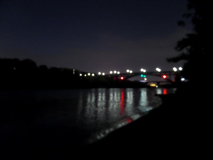 night time lights on a bridge over a river.