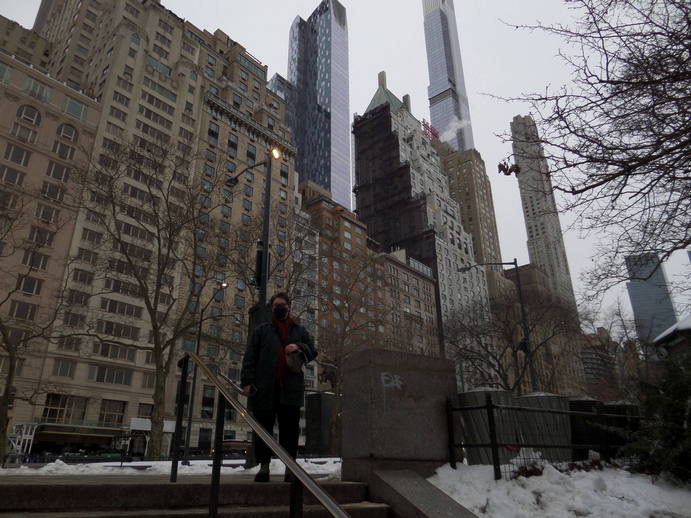 Olivia seems small against a background of giant buildings