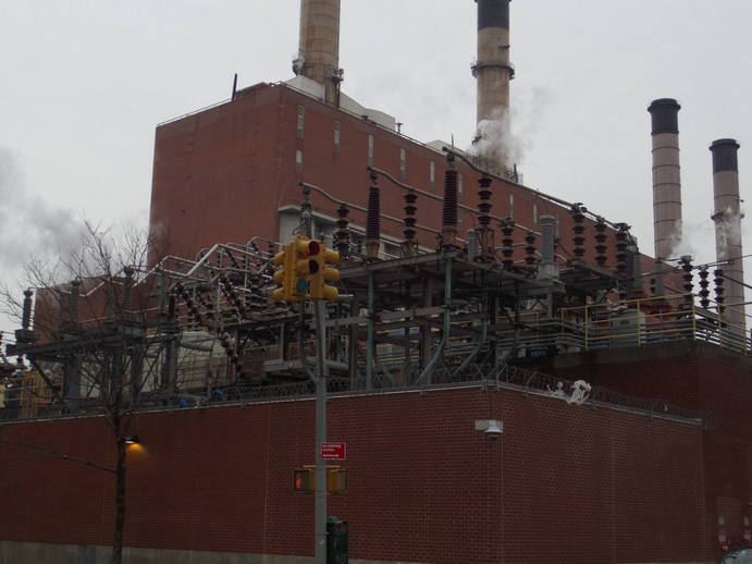 closer shot of powerplant with smokestacks.