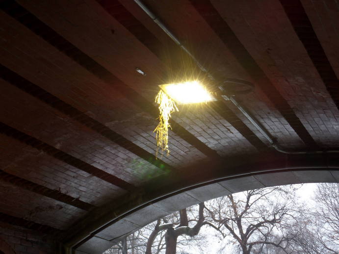 a square light on the underside of a tunnel opening.