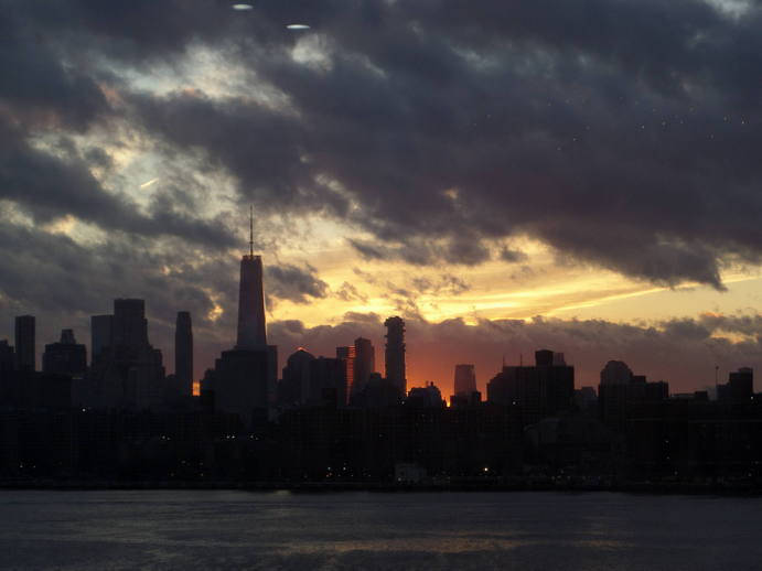 fiery sunset behind a skyline.