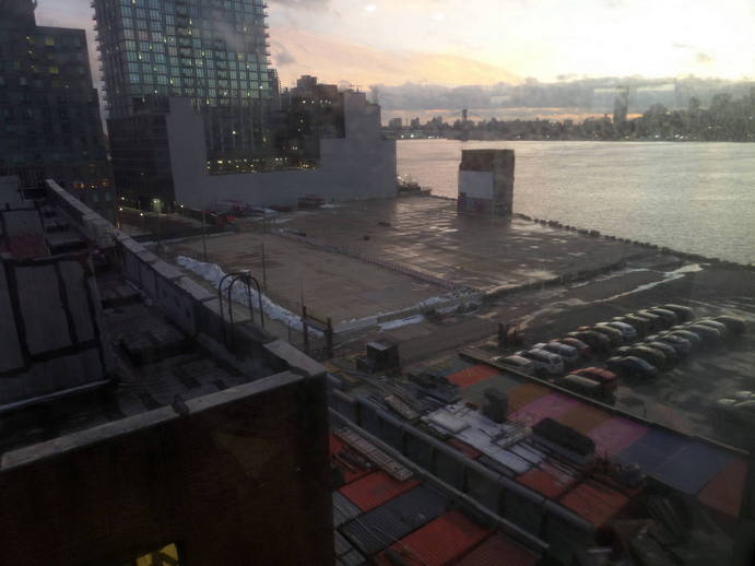 strange waterfront building at sunset from a great height.