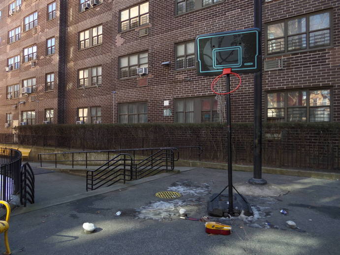 concrete park. basketball hoop with a smash guitar underneath it.