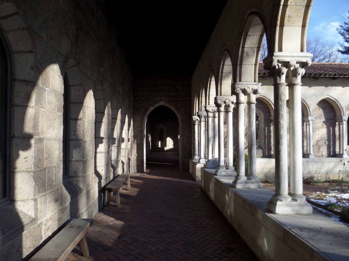 outdoor hallway, arched columns to a garden on the right.