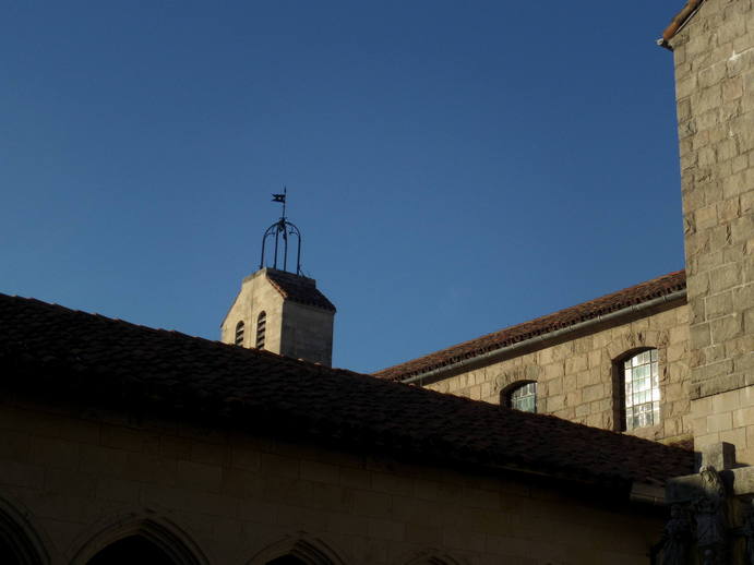 stone rooftops, a metal weathervane.