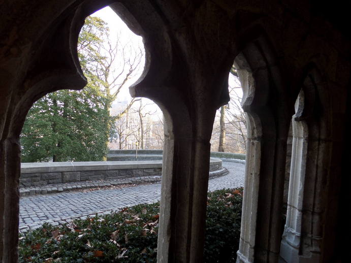 the cloister's exist, archways and a curving brick road.