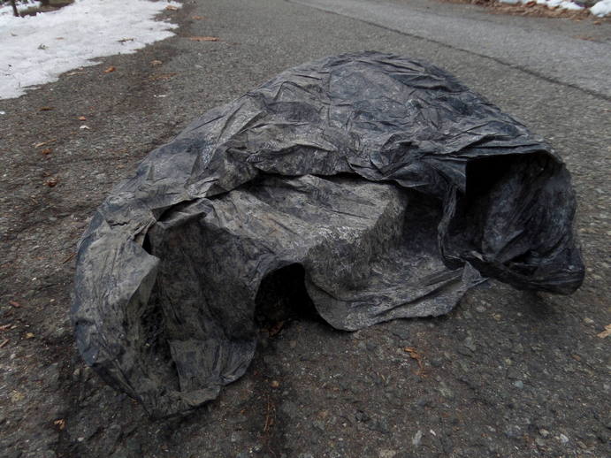 extremely weathered black plastic bag