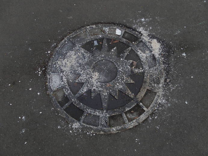 a compass rose embedded in the ground, icy.