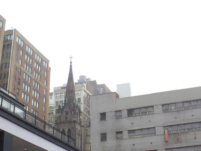 bright white sky, cathedral spire amid highrises