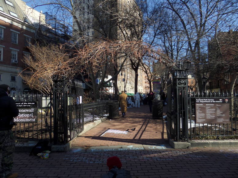 stonewall monument with chalk on the ground in front of the entrance saying 