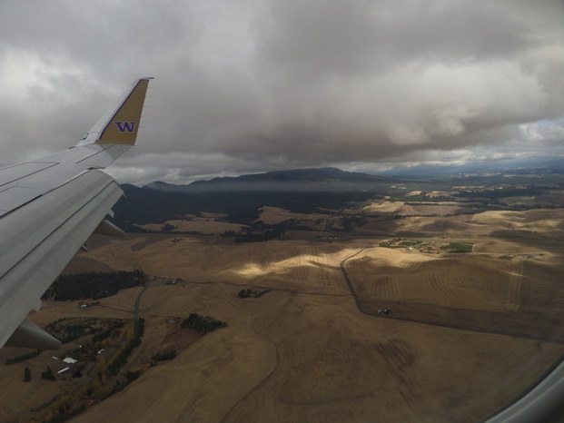 Rolling hills with a patch of light, view from an airplane.