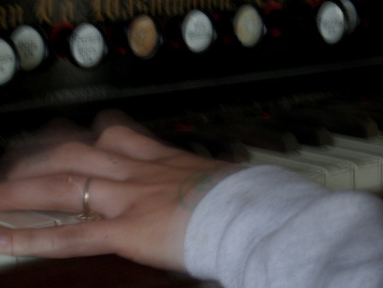 blurry hands on an organ