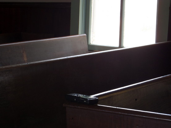 stark church pews with an audio recorder balanced on top