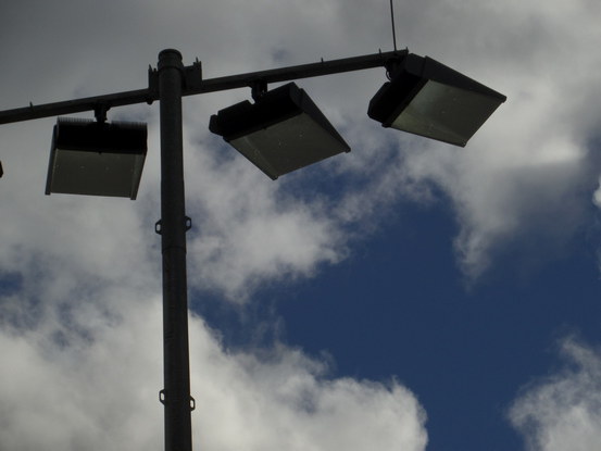 floodlights in front of delicate clouds.