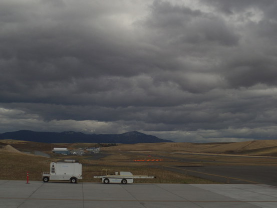 airstrip looking out at rolling hills then a blue mountain in the distance