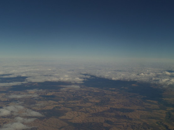 rolling hills out an airplane window, further still